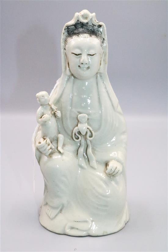 Chinese white glazed porcelain figure of Guanyin holding a child, Jiaqing period, 21cm, childs head re-stuck(-)